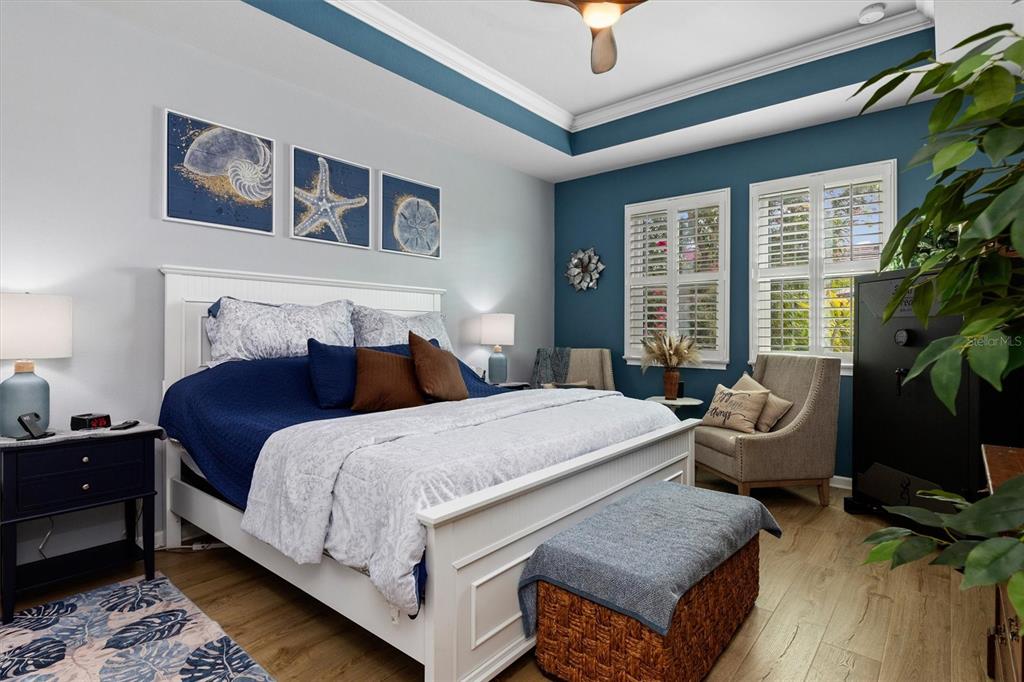 11819 Sistine Lane Venice, FL 34293 - Photo 20 of 90 a bedroom with a bed and a chandelier