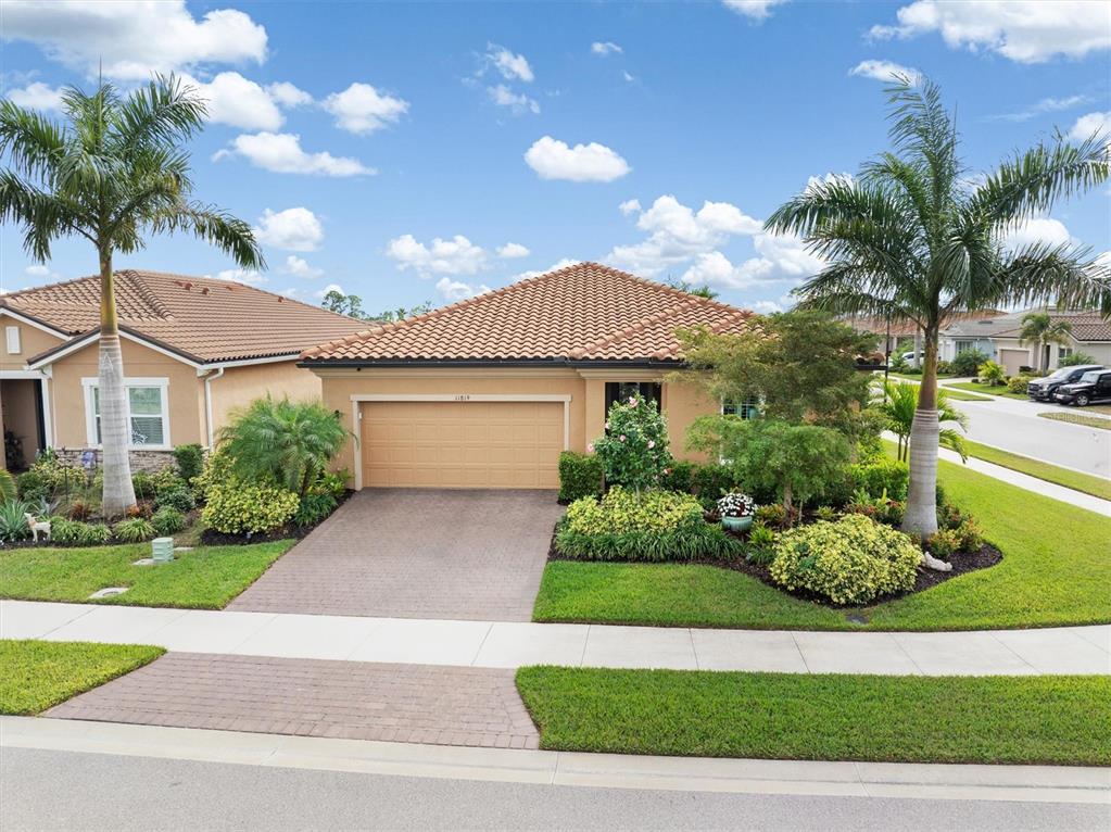 11819 Sistine Lane Venice, FL 34293 - Photo 34 of 90 a front view of a house with garden