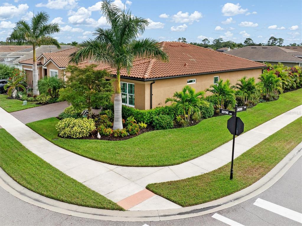 11819 Sistine Lane Venice, FL 34293 - Photo 35 of 90 a view of a white house with a yard and potted plants