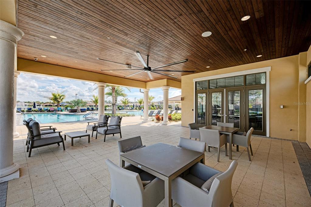 11819 Sistine Lane Venice, FL 34293 - Photo 57 of 90 a outdoor space with lots of tables a large window and furniture