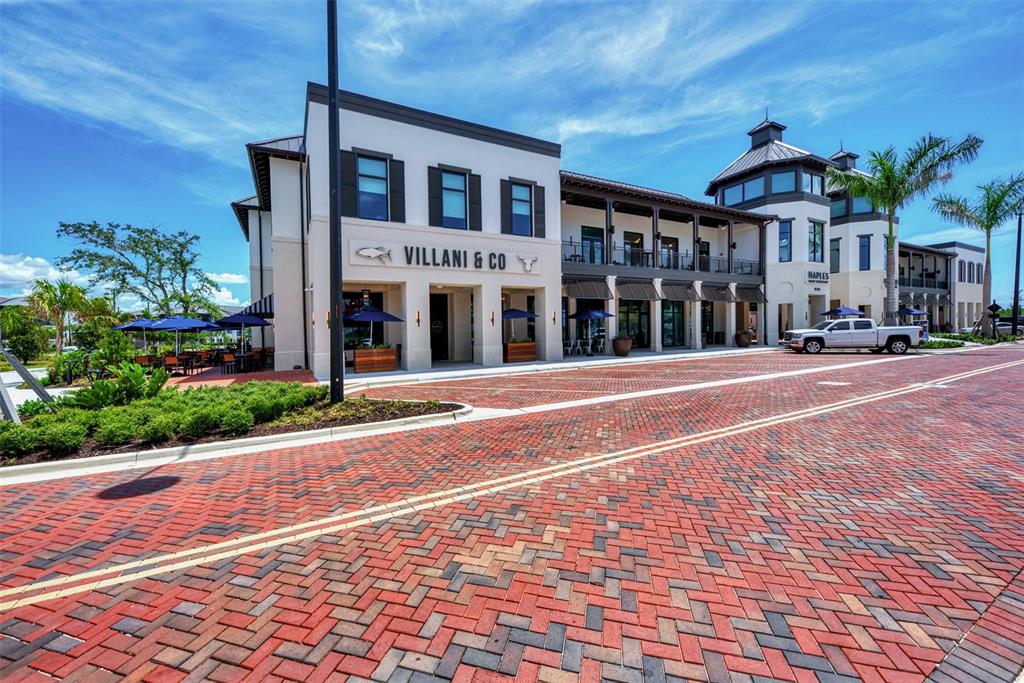 11819 Sistine Lane Venice, FL 34293 - Photo 84 of 90 a front view of a building with a garden