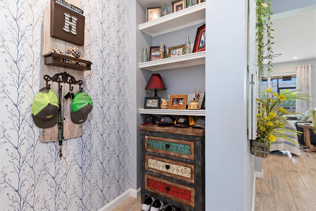 11819 Sistine Lane Venice, FL 34293 - Photo 10 of 90 a living room with furniture and a book shelf