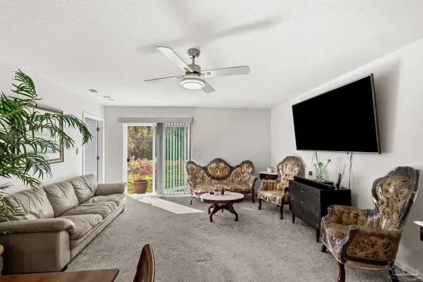 a kitchen with stainless steel appliances white cabinets and wooden floor