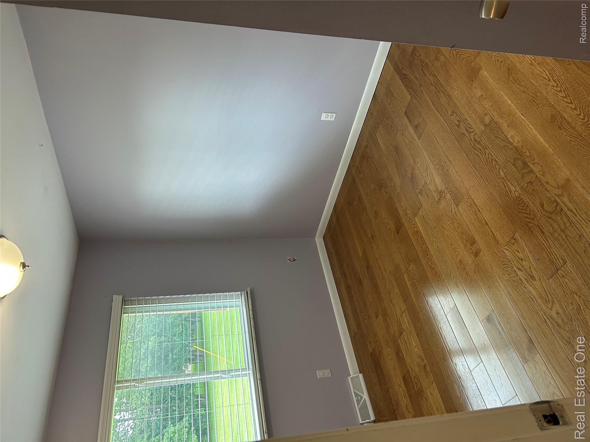 2659 Benstein Road Commerce Township, MI 48382 - Photo 16 of 26 Room featuring wood-finish flooring, a double window with blinds, and a semi-flush mount ceiling light