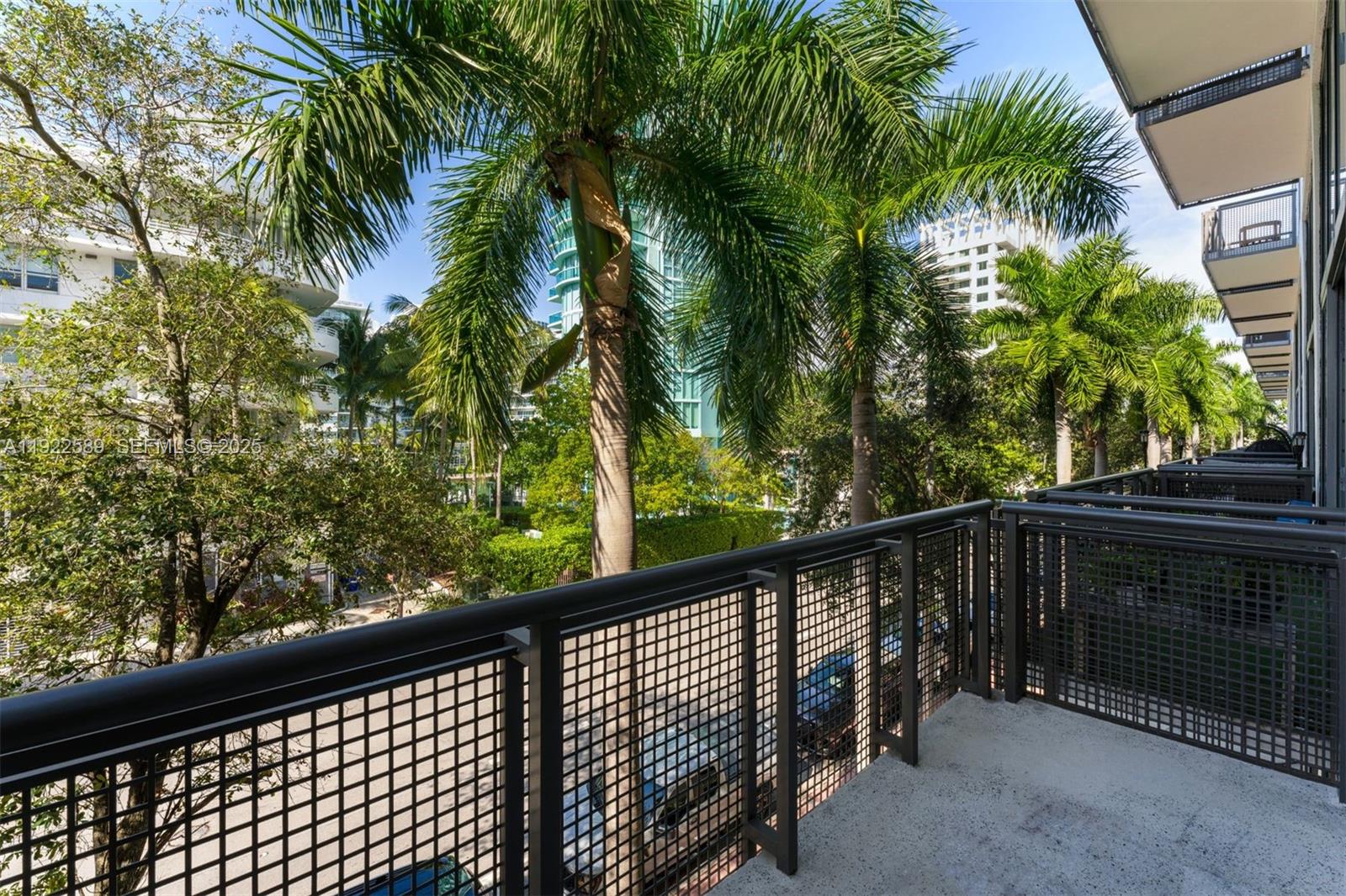 6000 Collins Avenue, Unit 330 Miami Beach, FL 33140 - Photo 11 of 25 a view of balcony with wooden floor and fence