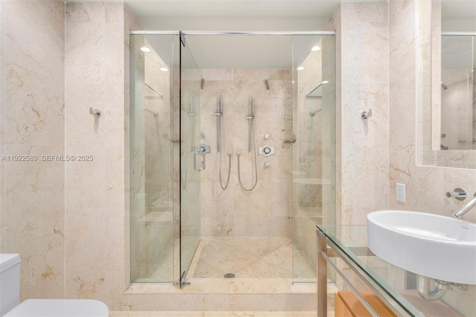 6000 Collins Avenue, Unit 330 Miami Beach, FL 33140 - Photo 22 of 25 a bathroom with a shower and a toilet
