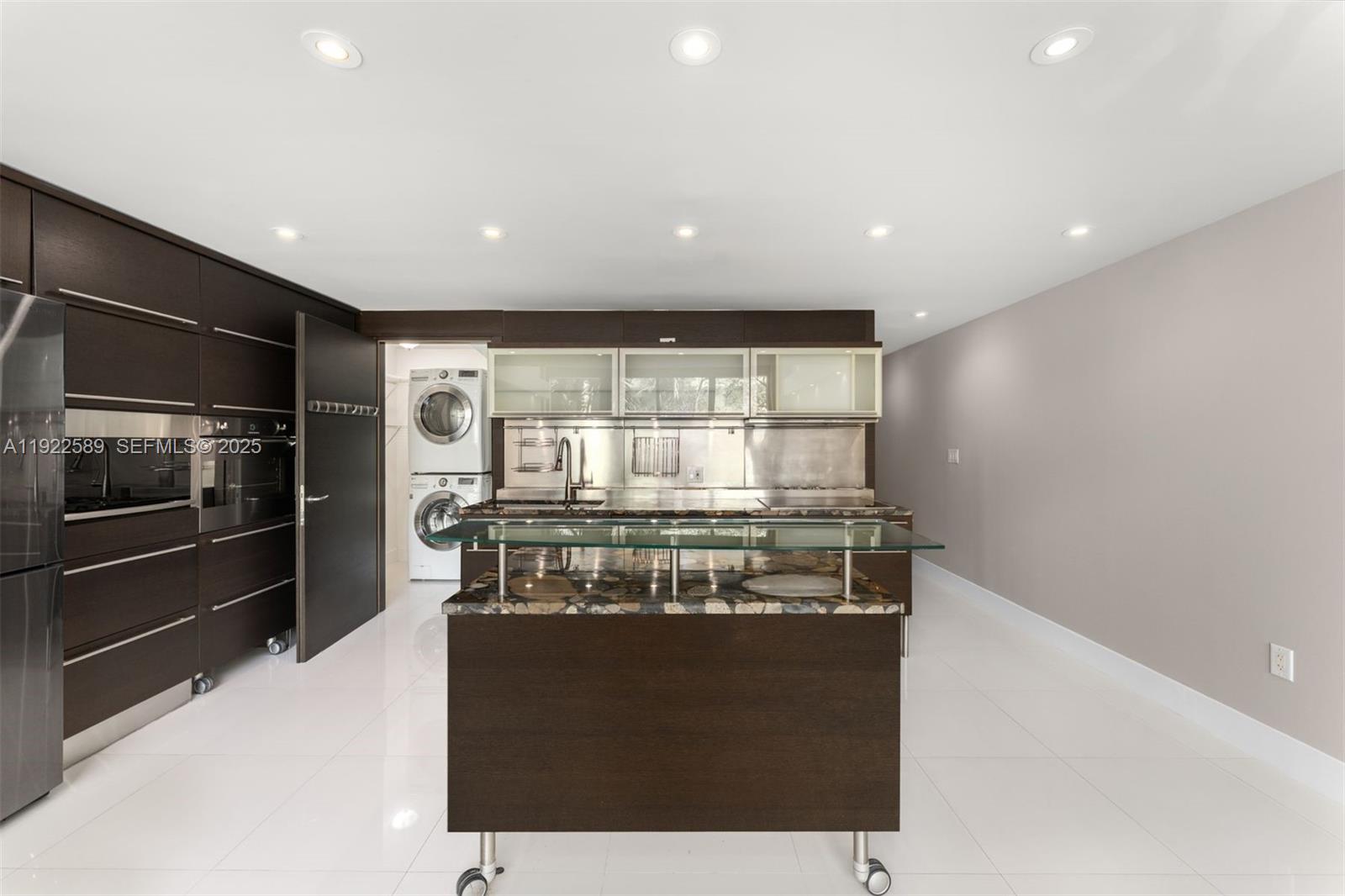 6000 Collins Avenue, Unit 330 Miami Beach, FL 33140 - Photo 3 of 25 a kitchen with a stove and a refrigerator