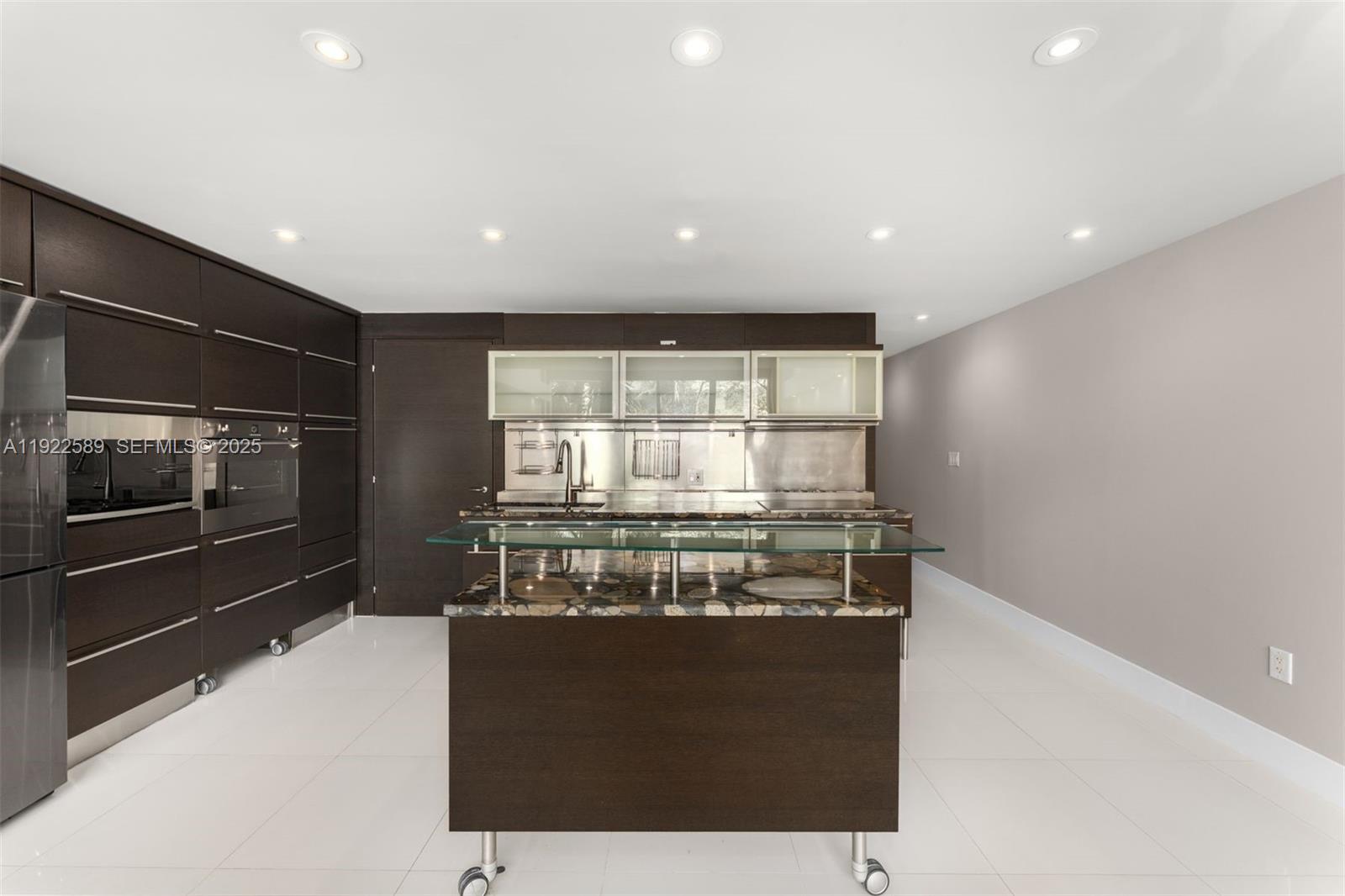 6000 Collins Avenue, Unit 330 Miami Beach, FL 33140 - Photo 4 of 25 a kitchen with a stove and a refrigerator