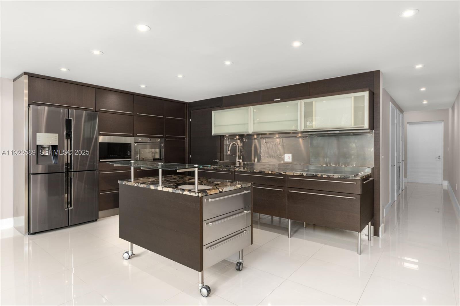 6000 Collins Avenue, Unit 330 Miami Beach, FL 33140 - Photo 5 of 25 a kitchen with stainless steel appliances granite countertop a refrigerator and a stove