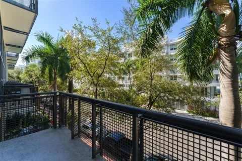 a view of a balcony with a tree