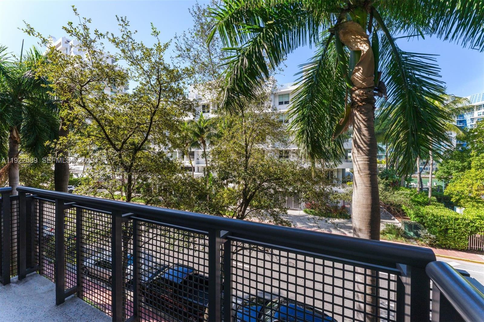 6000 Collins Avenue, Unit 330 Miami Beach, FL 33140 - Photo 10 of 25 a view of a balcony with a palm tree