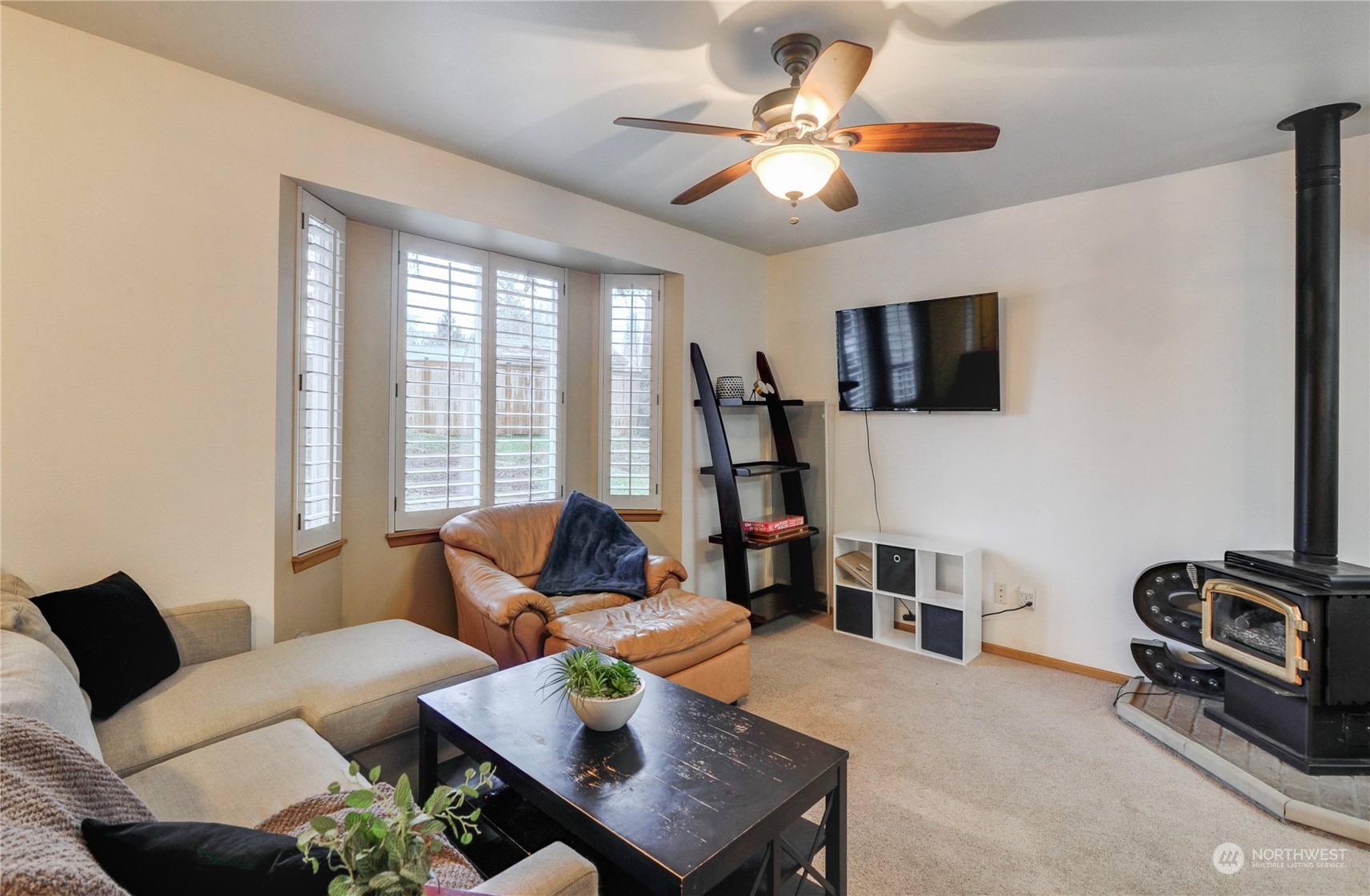 310 216th Street Southwest Bothell, WA 98021 - Photo 3 of 28 a living room with furniture a flat screen tv and a window