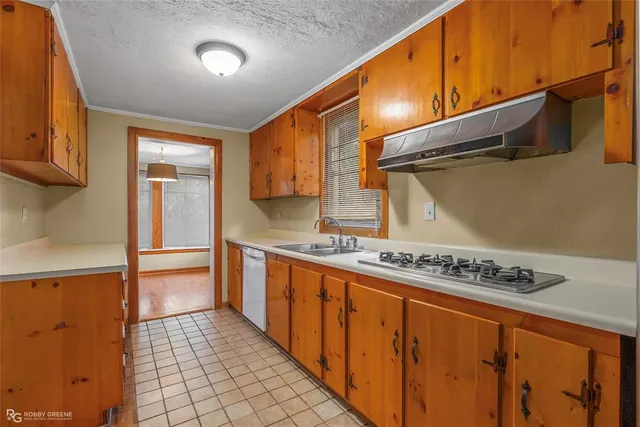 a kitchen with stainless steel appliances granite countertop a sink and cabinets