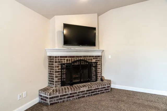 a living room with a fireplace and a flat screen tv
