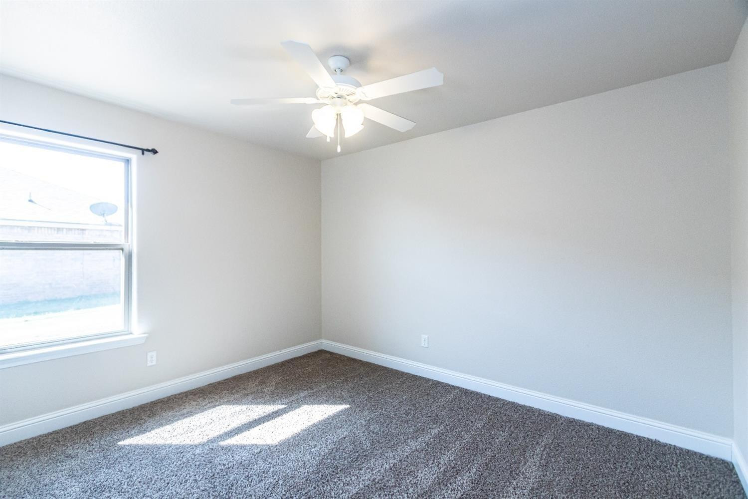 9706 Ridgely Avenue Lubbock, TX 79424 - Photo 25 of 32 an empty room with a window