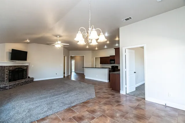 a view of a kitchen with a sink and a large mirror