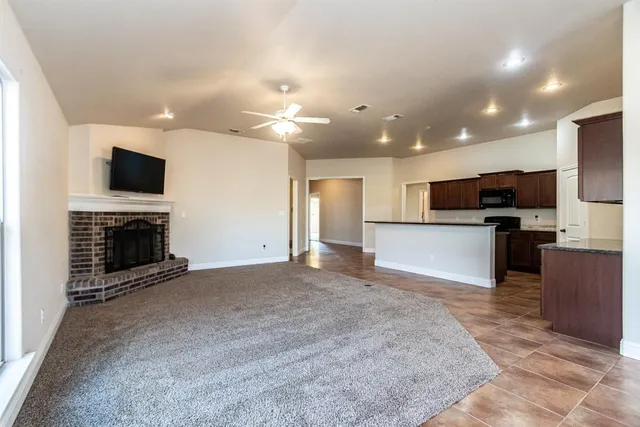 a view of kitchen with kitchen island microwave and stove top oven