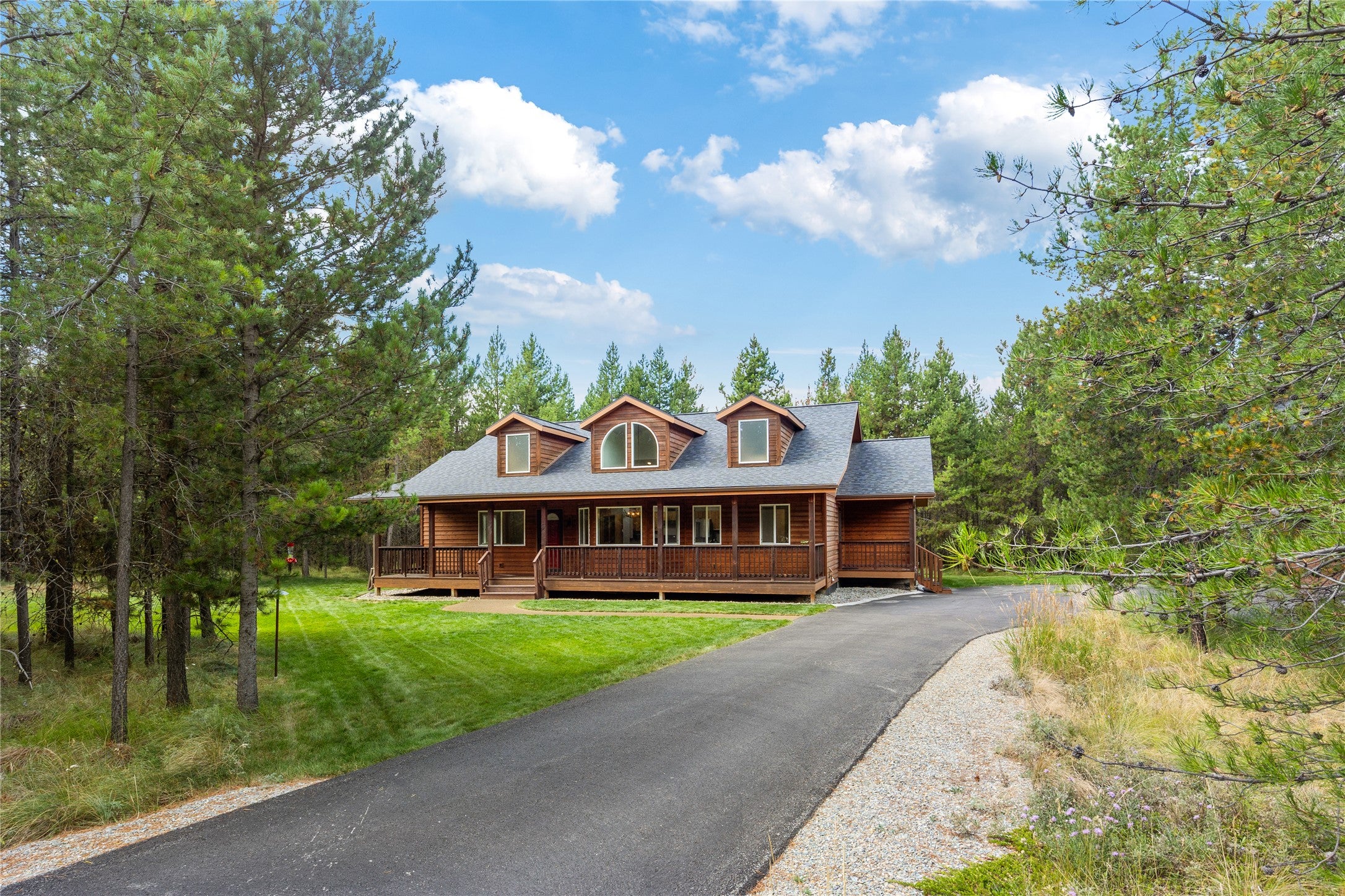 155 Wright Way Marion, MT 59925 - Photo 1 of 1 View of front of house featuring covered porch and a front lawn