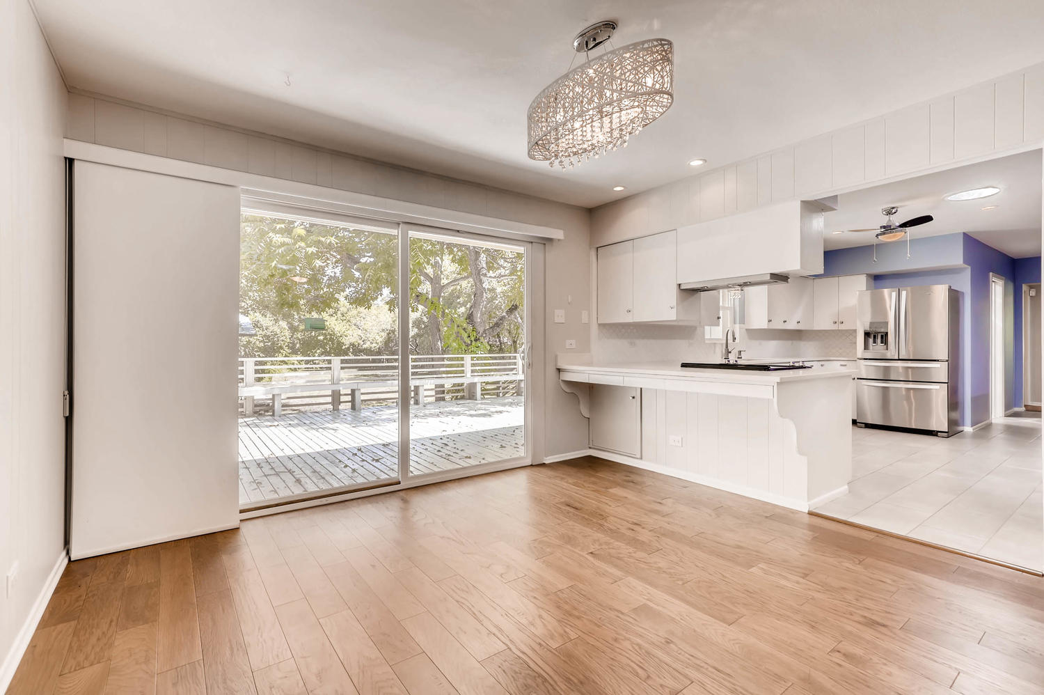 446 Pike Road San Antonio, TX 78209 - Photo 12 of 28 A luminous living space opens to the outside with expansive sliding doors and polished hardwood floors.