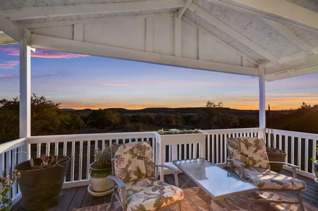 a view of a chair and table on the roof deck
