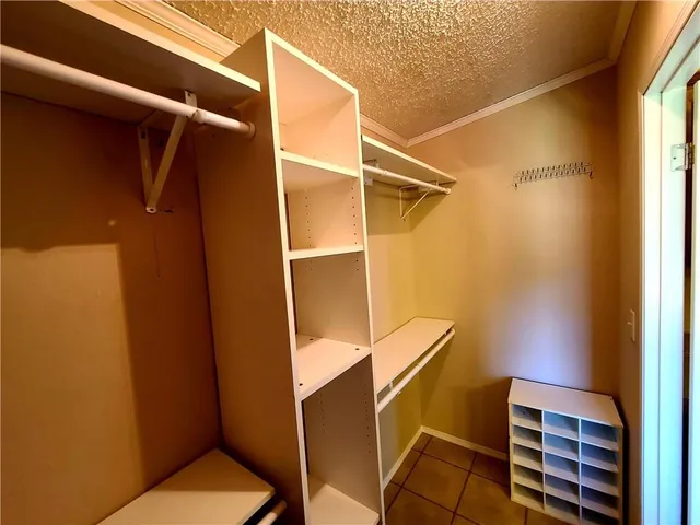 a view of walk in closet with clothes