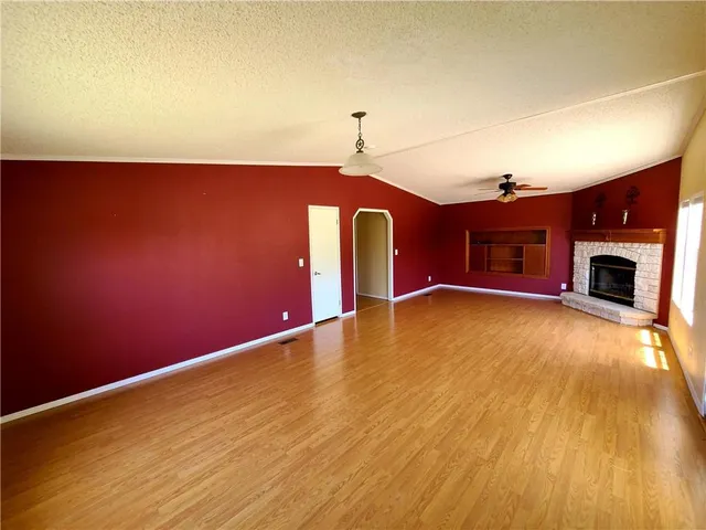 a view of an empty room with a fireplace