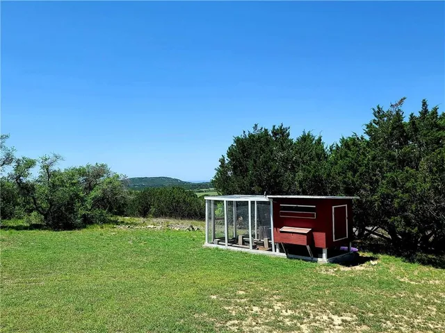 a view of house with backyard space and sitting area