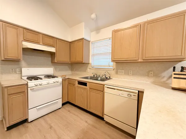 a kitchen with a sink stove and cabinets