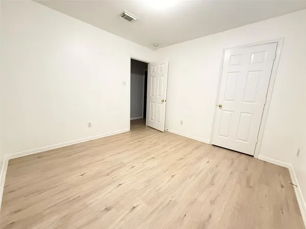an empty room with wooden floor