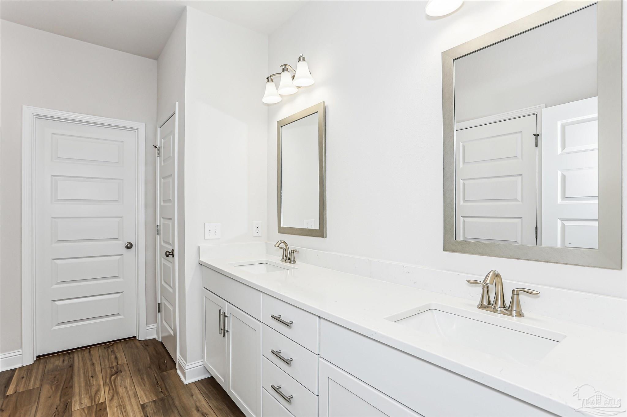 1644 Slate Drive Cantonment, FL 32533 - Photo 14 of 28 a bathroom with a double vanity sink and a mirror