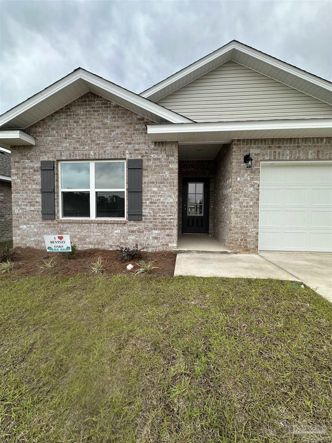 1644 Slate Drive Cantonment, FL 32533 - Photo 2 of 28 a front view of a house with a yard