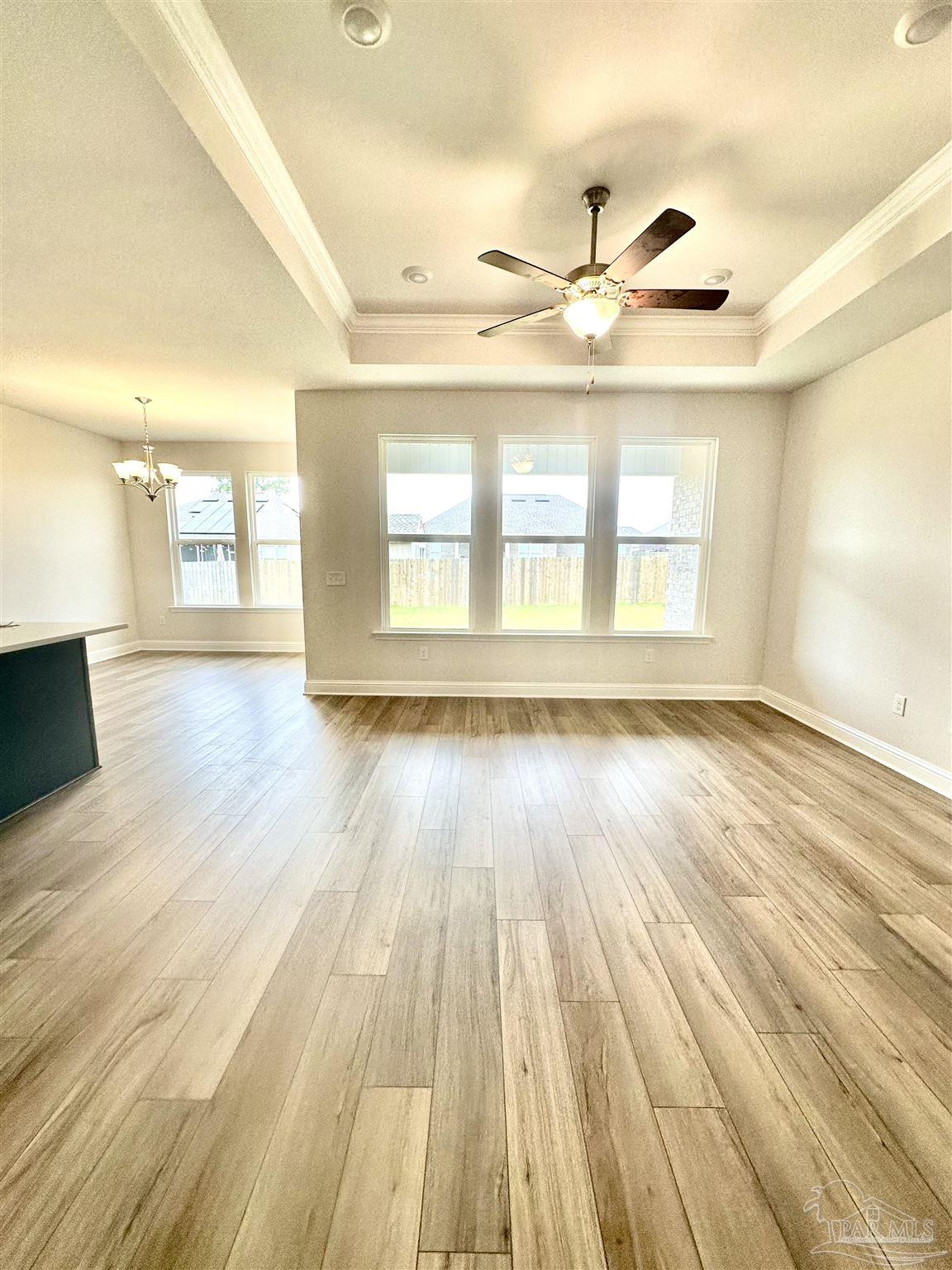 1644 Slate Drive Cantonment, FL 32533 - Photo 24 of 28 a view of an empty room with wooden floor and a window