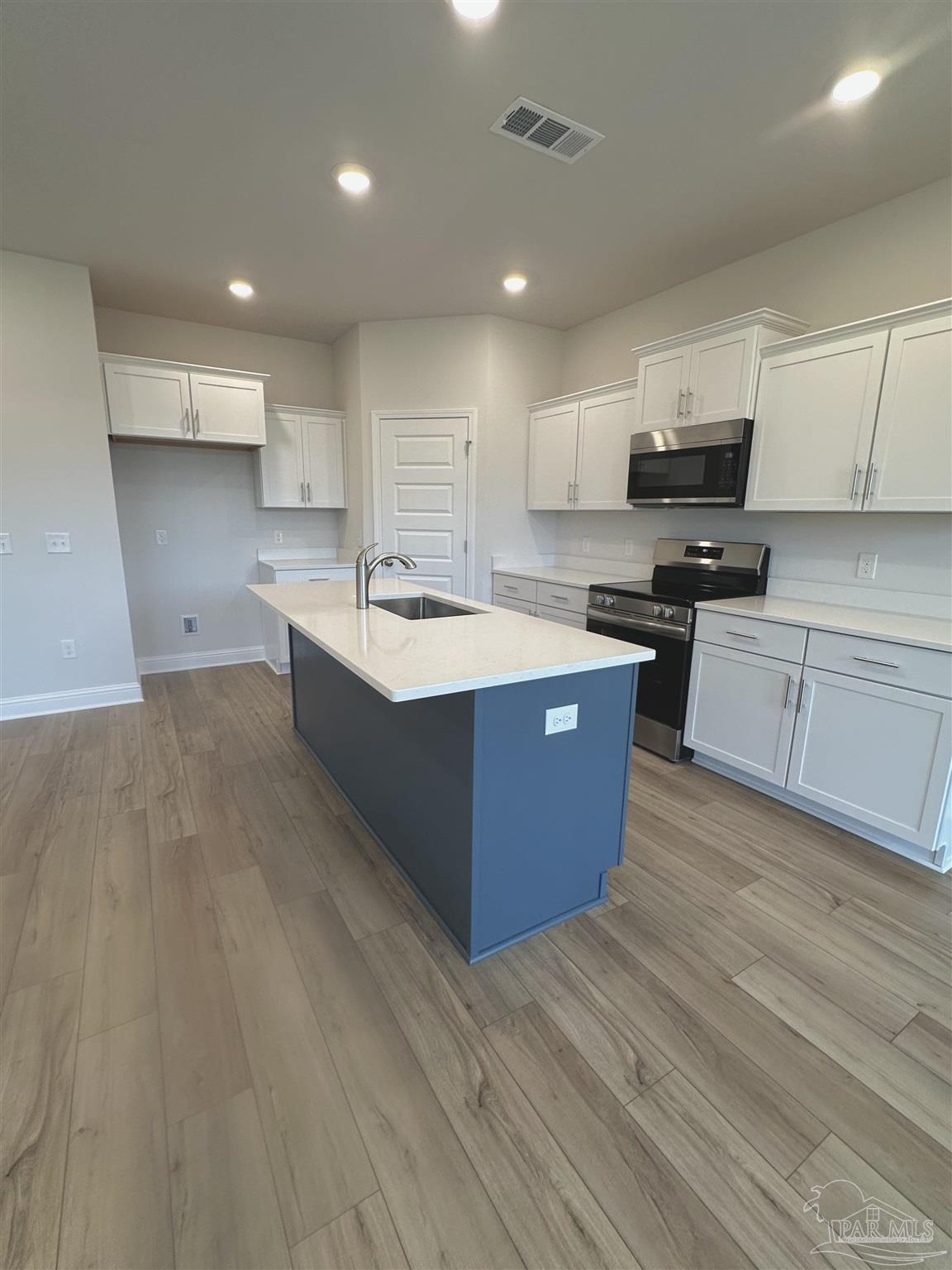 1644 Slate Drive Cantonment, FL 32533 - Photo 7 of 28 a kitchen with a sink and cabinets
