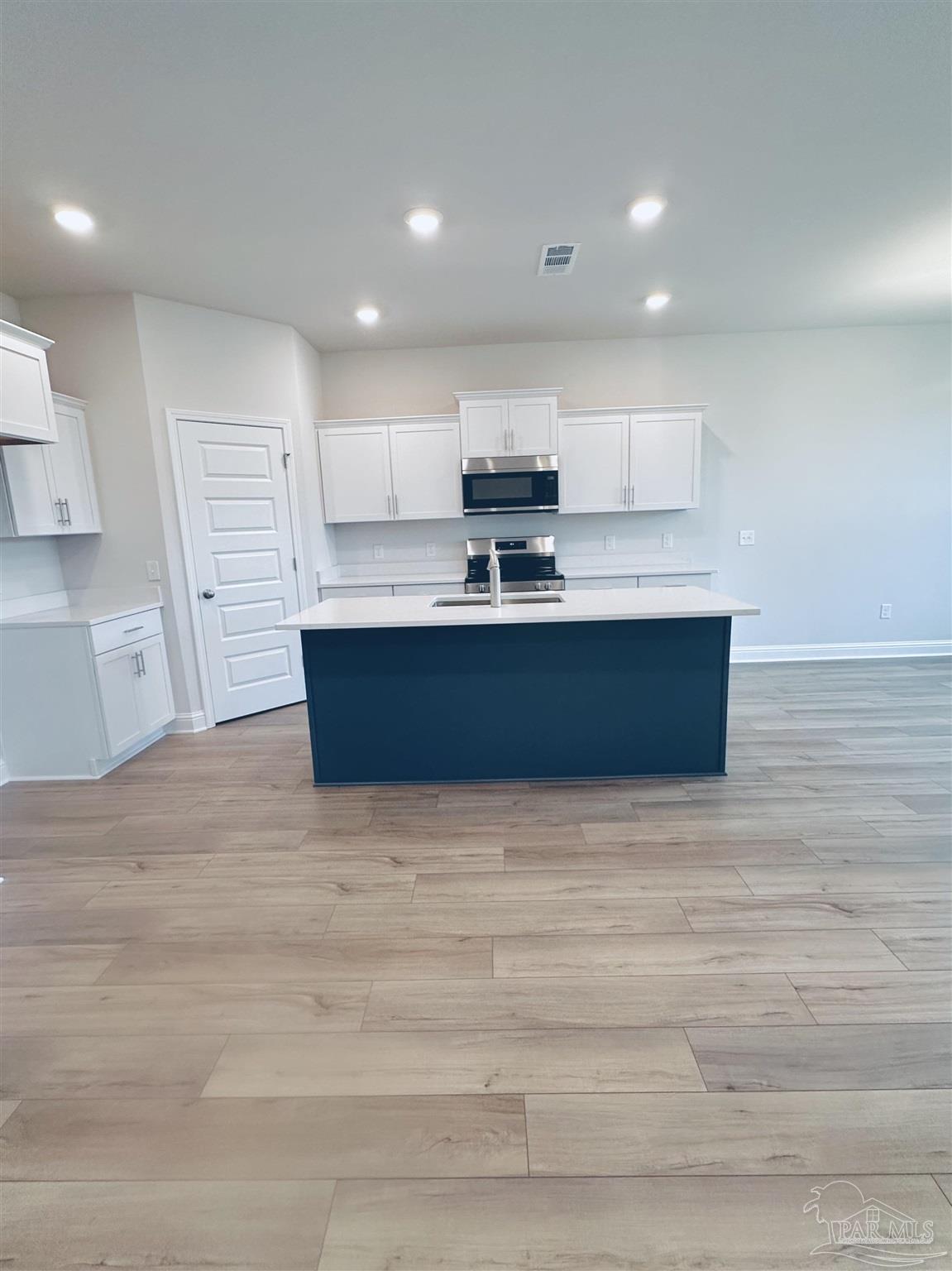 1644 Slate Drive Cantonment, FL 32533 - Photo 8 of 28 a view of kitchen with microwave stove refrigerator and cabinets