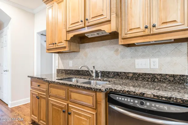 a kitchen with stainless steel appliances granite countertop a stove and a refrigerator