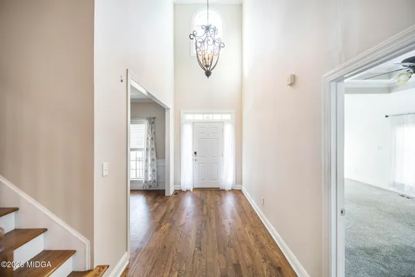 a view of hallway with wooden floor