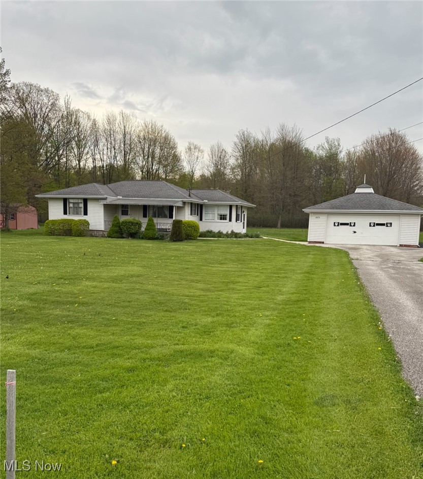 6675 Liberty Road Solon, OH 44139 - Photo 1 of 1 Ranch-style home featuring an outdoor structure, a garage, and a front yard