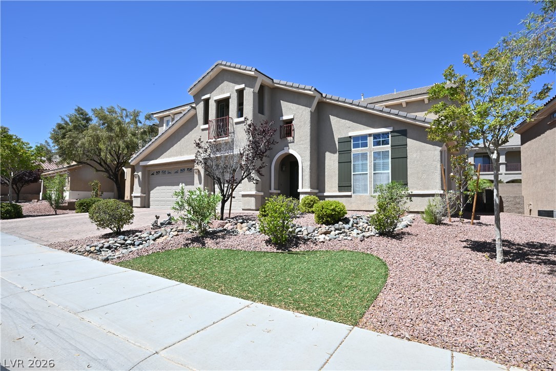 2729 Kildrummie Street Henderson, NV 89044 - Photo 2 of 42 A meticulously maintained stucco residence with an arched entry and charming front garden beckons.