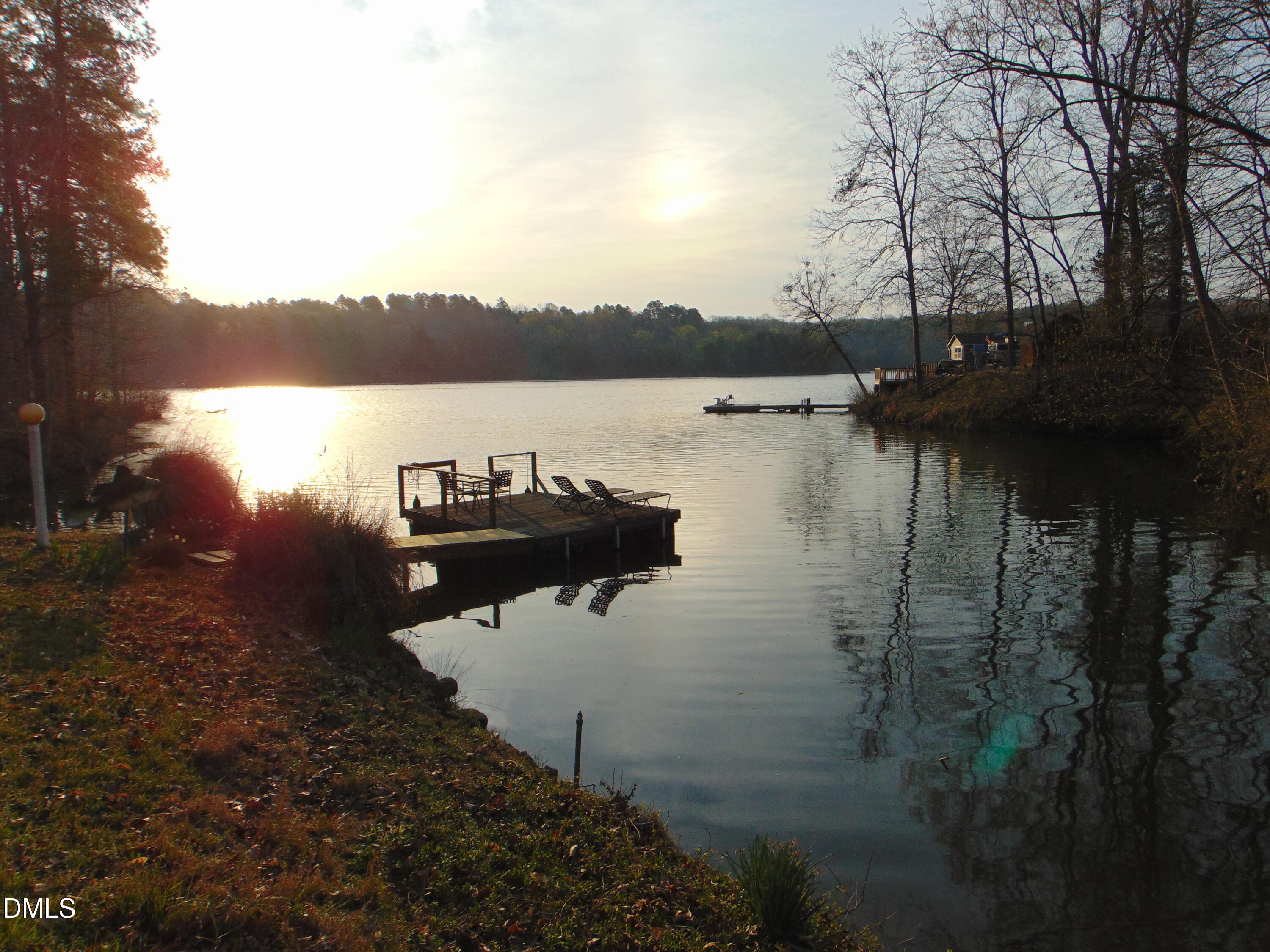 130 Lake View Road Prospect Hill, NC 27314 - Photo 49 of 73 a lake view with boat and palm trees