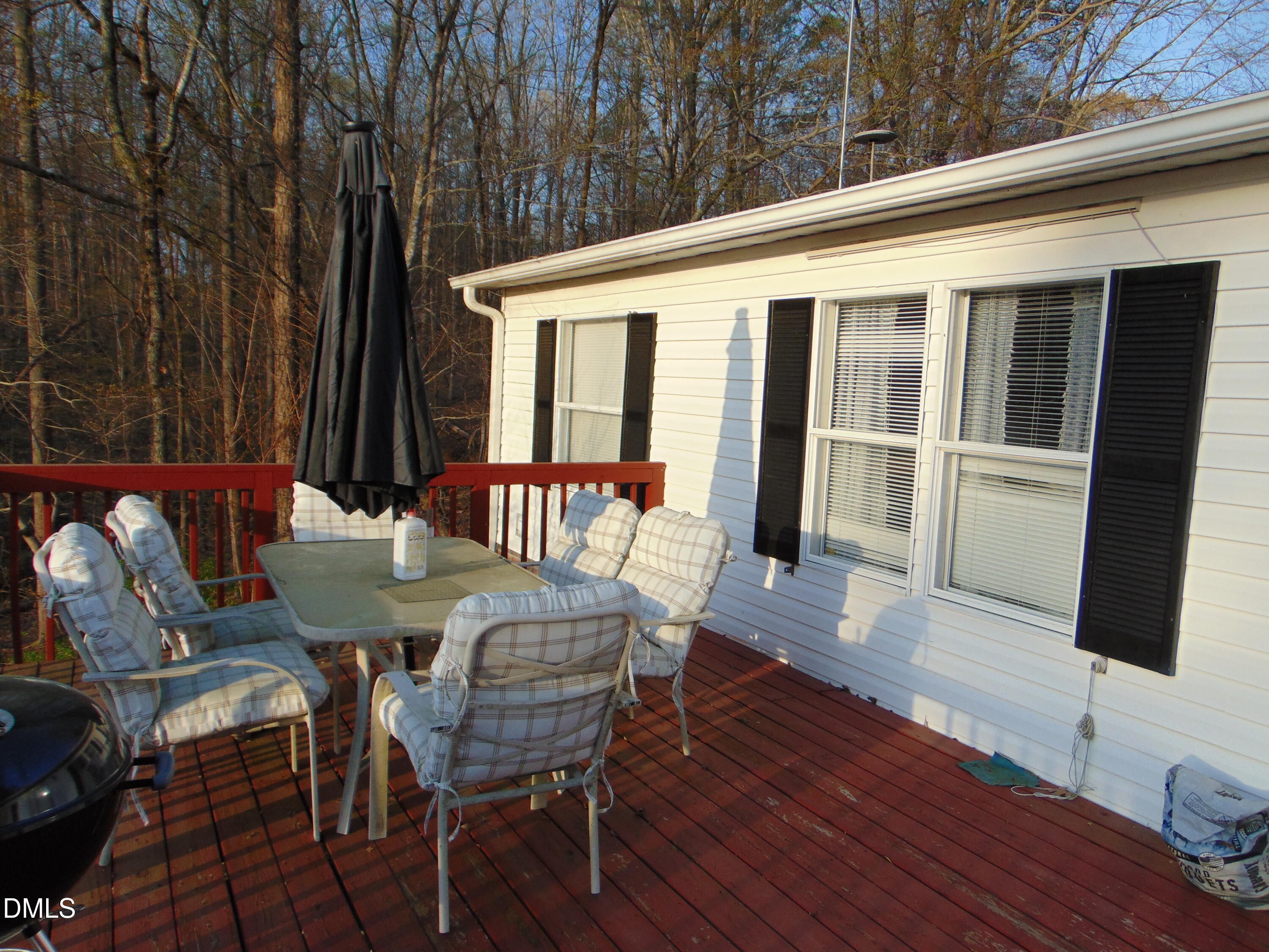 130 Lake View Road Prospect Hill, NC 27314 - Photo 51 of 73 a view of a patio with table and chairs with wooden floor and fence