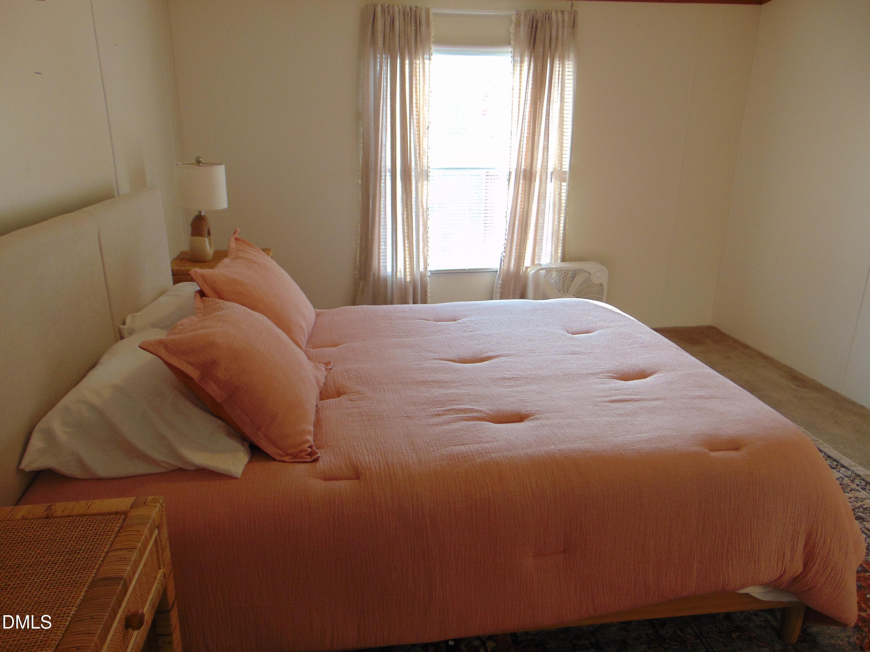 130 Lake View Road Prospect Hill, NC 27314 - Photo 57 of 73 a bed sitting in a bedroom next to a window
