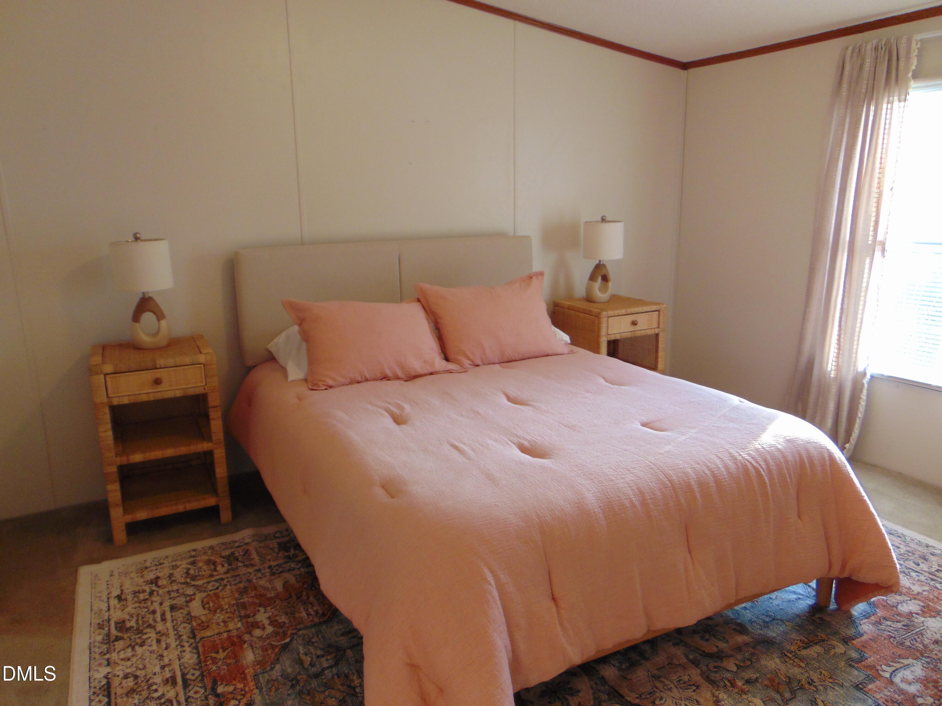 130 Lake View Road Prospect Hill, NC 27314 - Photo 58 of 73 a bed sitting in a bedroom next to a window