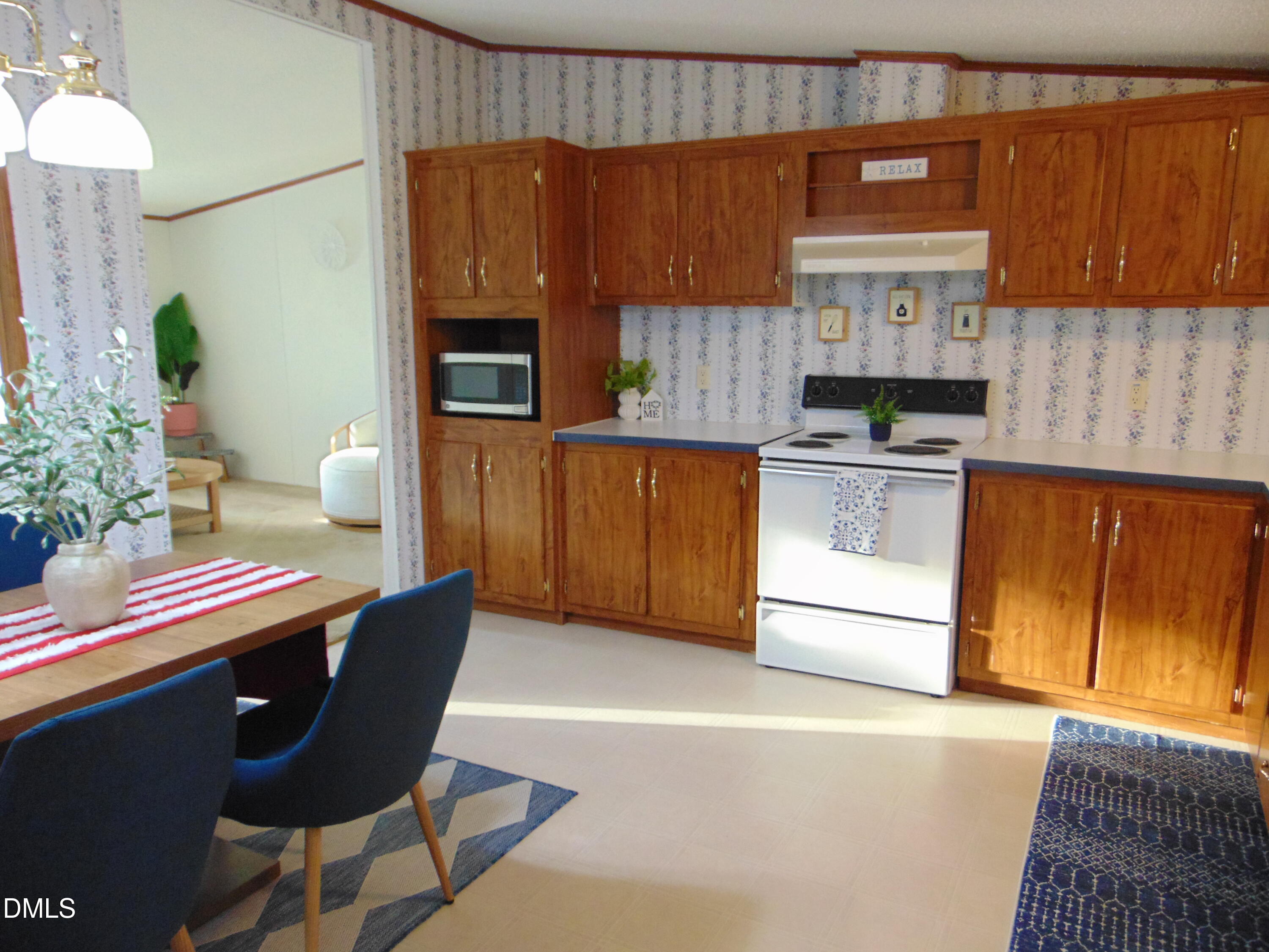 130 Lake View Road Prospect Hill, NC 27314 - Photo 62 of 73 a kitchen with stainless steel appliances a stove a sink a microwave a refrigerator and cabinets
