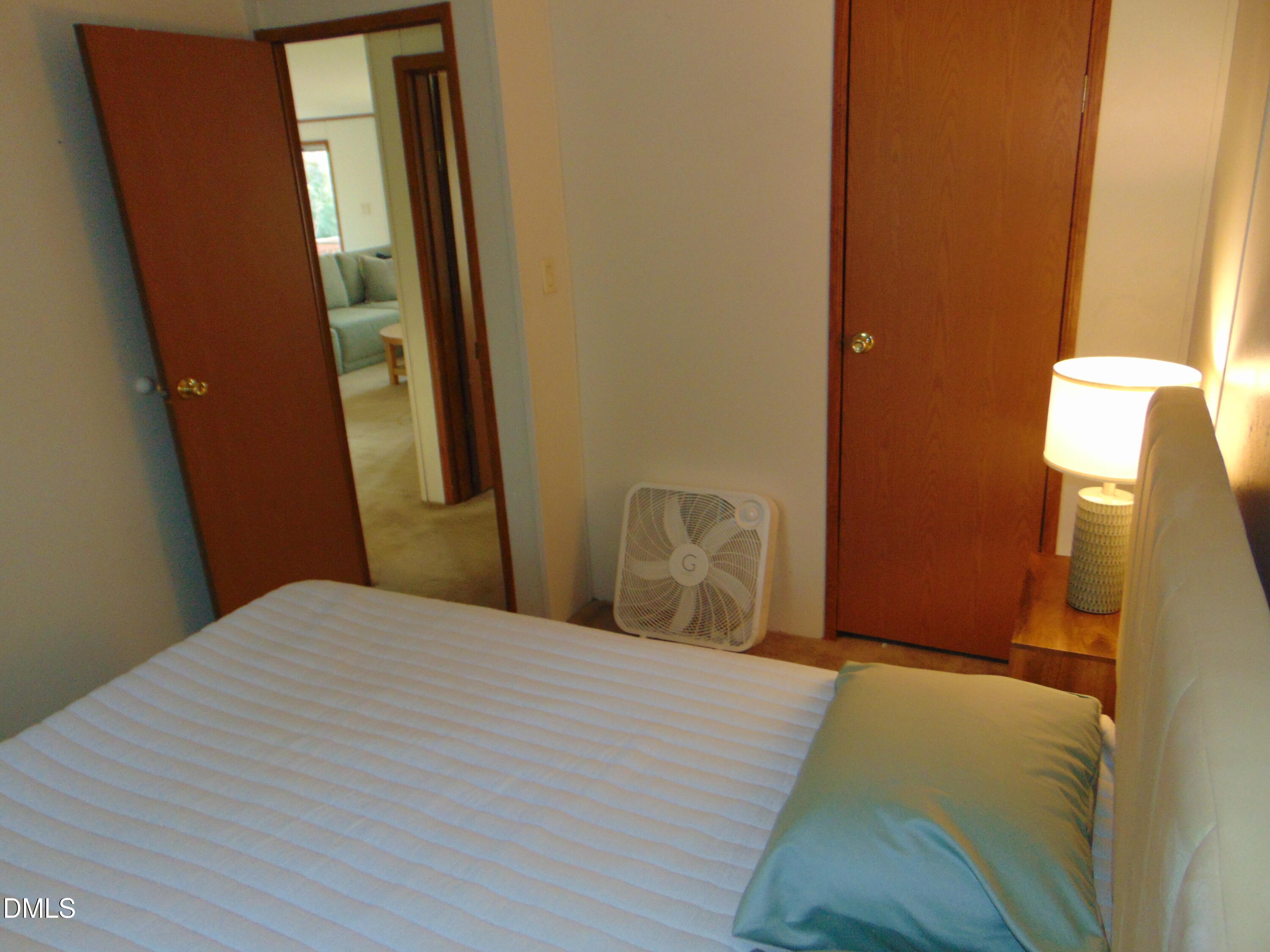 130 Lake View Road Prospect Hill, NC 27314 - Photo 65 of 73 a bedroom with a bed and a mirror