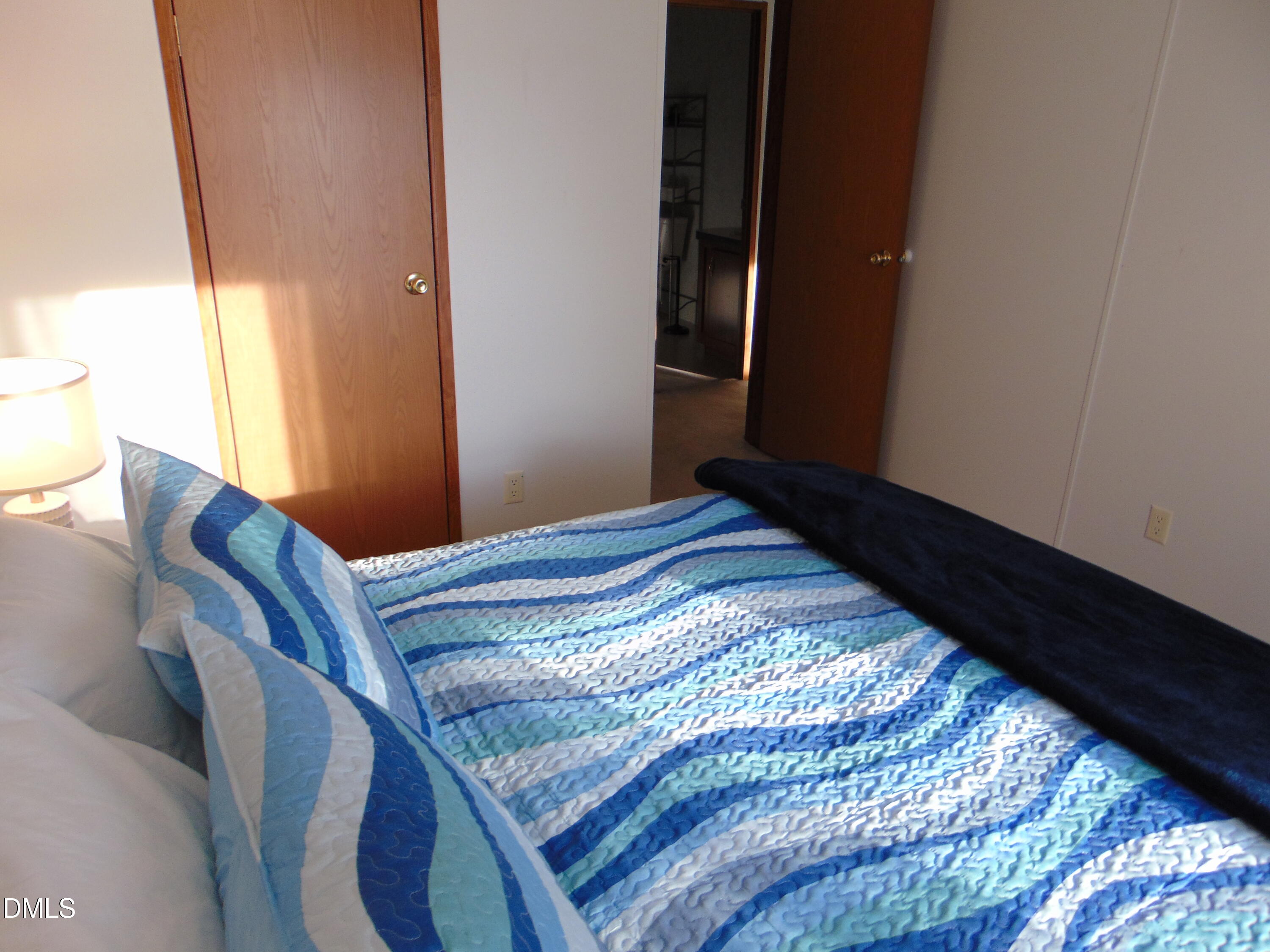 130 Lake View Road Prospect Hill, NC 27314 - Photo 66 of 73 a bedroom with a bed and wooden floor