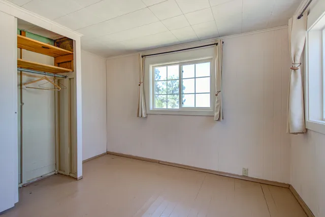 a view of an empty room and a bedroom