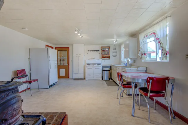a living room with furniture and a kitchen view