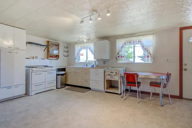 a kitchen that has a lot of cabinets in it and a window