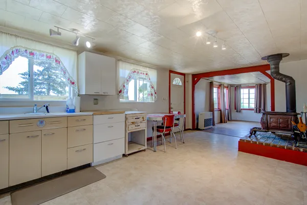 a very nice looking bedroom with a large window and furniture