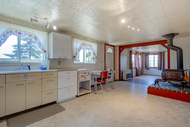 a very nice looking bedroom with a large window and furniture